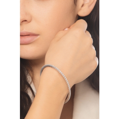 Bracelet tennis griffe elastique en or blanc 750 avec diamants